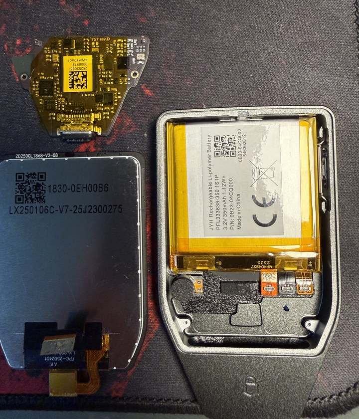 Opened Trezor Safe 7 with its display, circuit board and battery laid out
